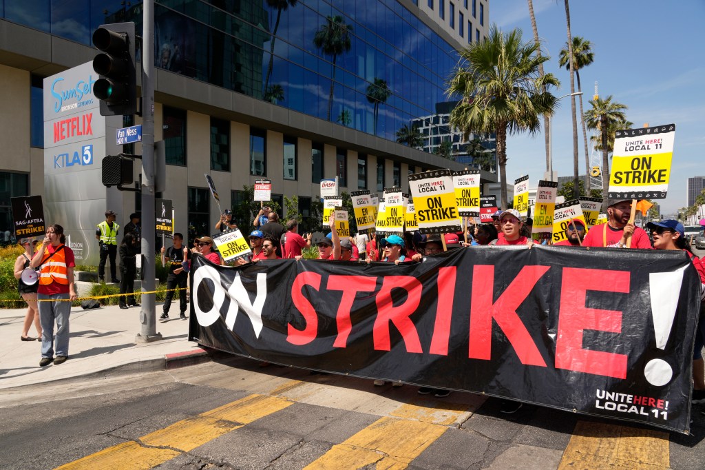 Striking Hotel workers from Unite Here Local 11 join the picketing actors of SAG-AFTRA, and writers of the WGA, outside Netflix studios on July 21, 2023, in Los Angeles. (AP Photo/Chris Pizzello, File)