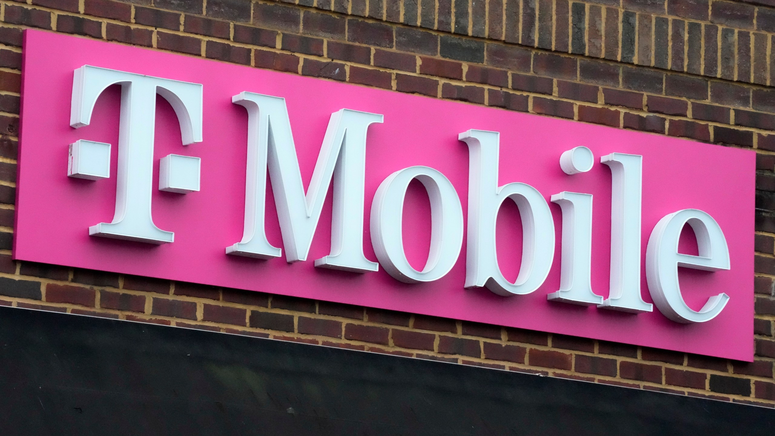 FILE - The sign for a T-Mobile store is seen, Jan. 30, 2023, in Pittsburgh. T-Mobile plans to cut 5,000 jobs, or about 7% of its workforce, the U.S. wireless carrier announced Thursday, Aug. 24. (AP Photo/Gene J. Puskar, File)