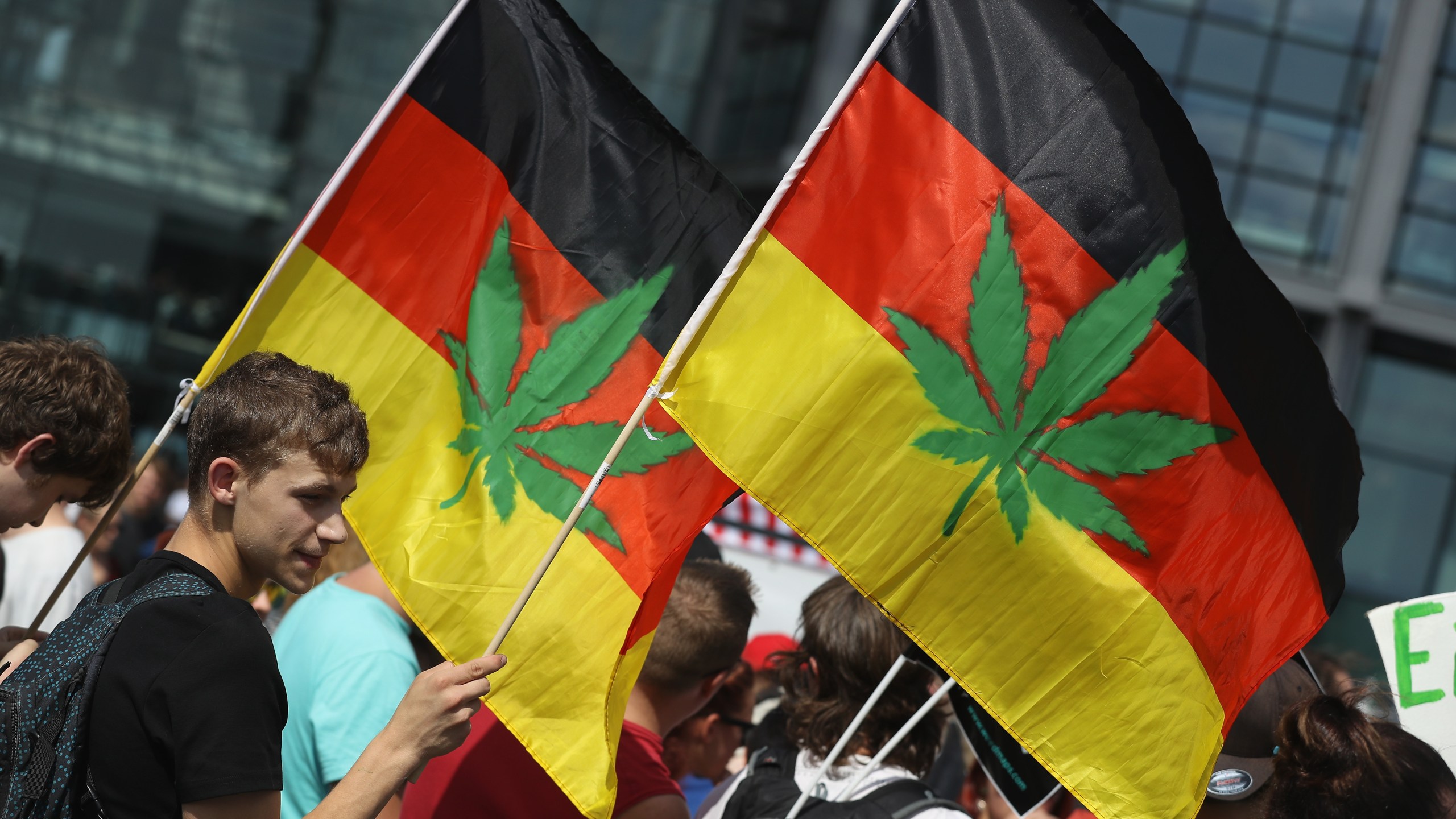 Activists, including two waving German flags that have a marijuana leaf painted on them, demanding the legalization of marijuana prepare to march in the annual Hemp Parade (Hanfparade) on Aug. 13, 2016, in Berlin, Germany. (Sean Gallup/Getty Images)