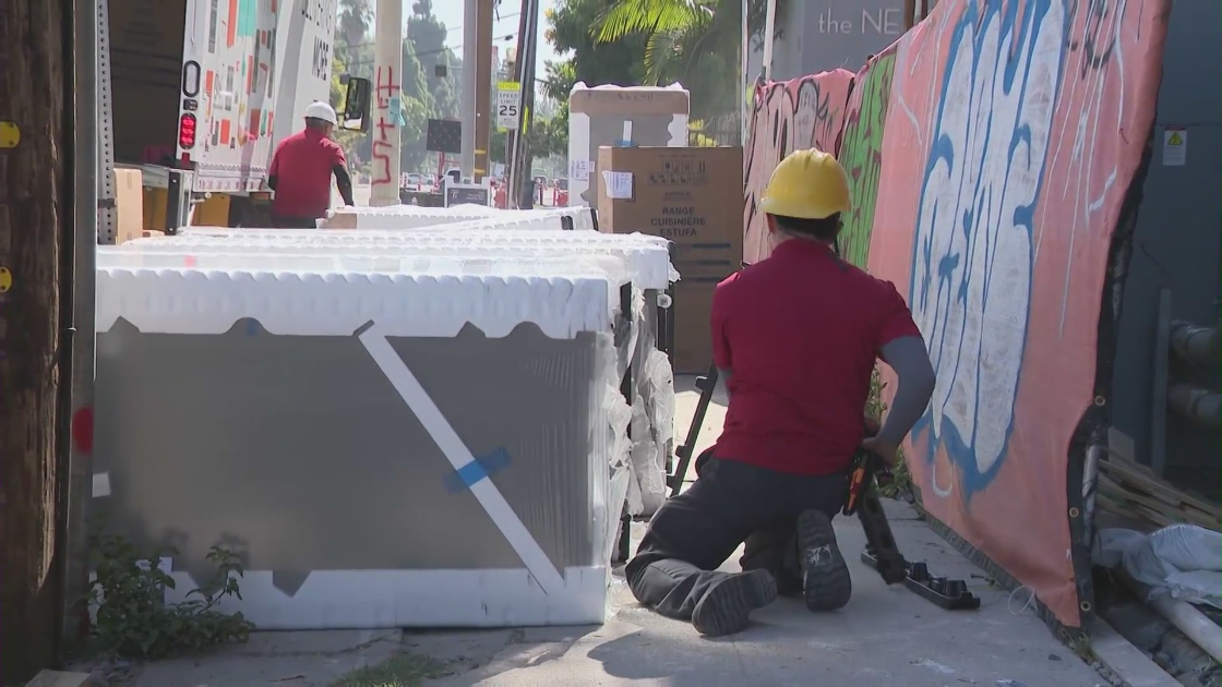 A construction crew works on an apartment building near the USC campus on Aug. 29, 2023. (KTLA)