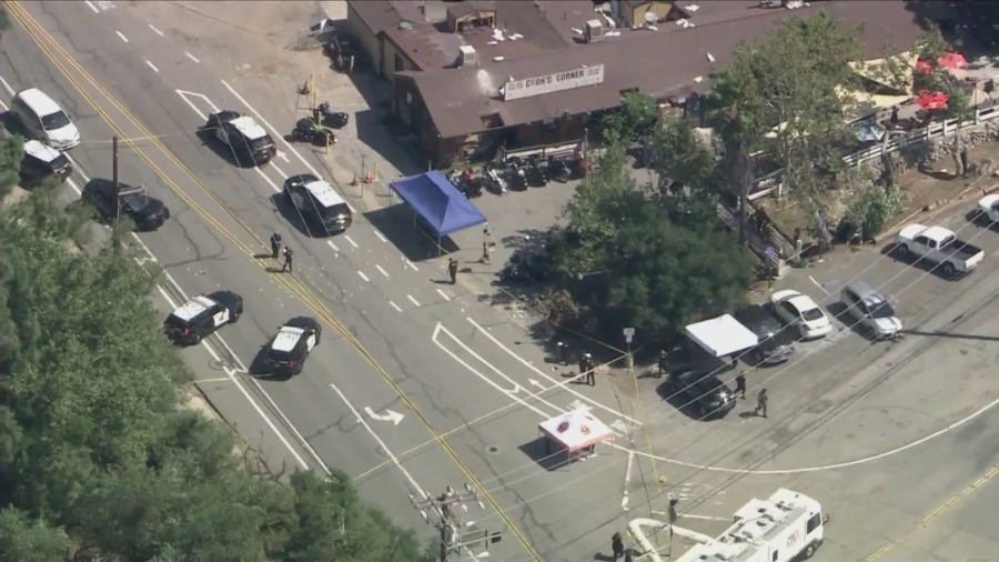 Investigators scour the scene of a mass shooting in Trabuco Canyon on Aug. 24, 2023, a day after the massacre. (KTLA)