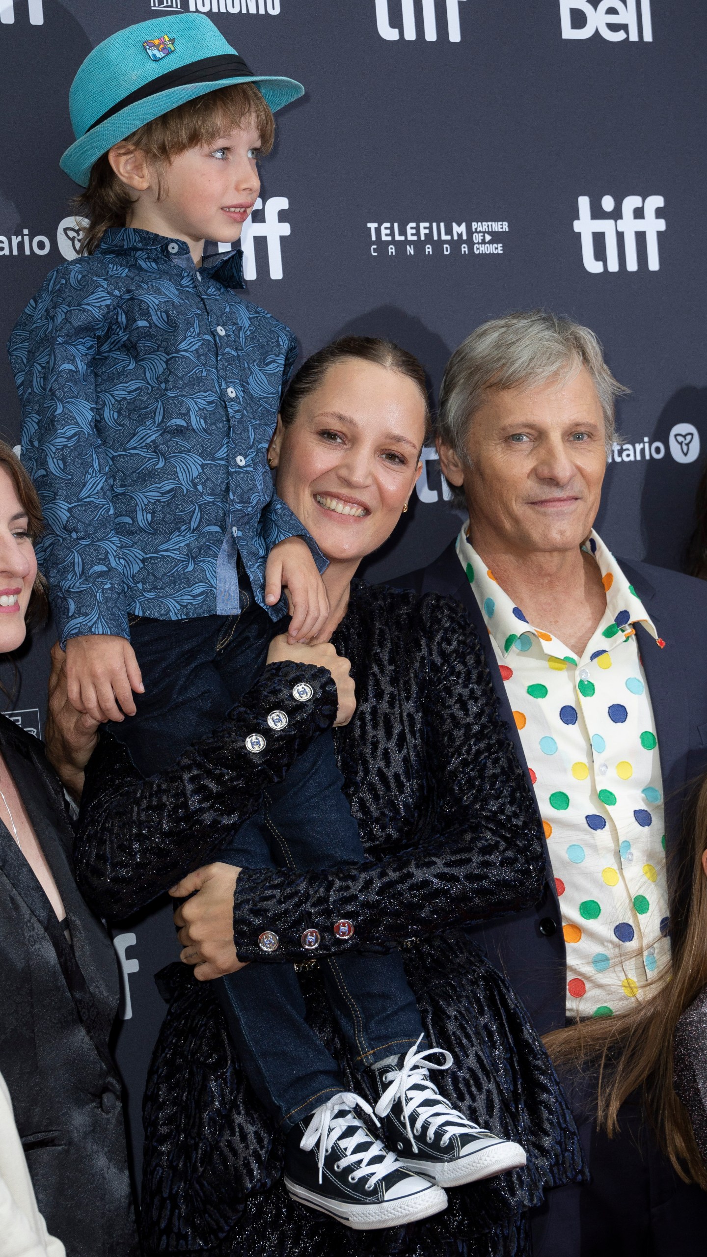 Vicky Krieps holds Atlas Green in her arms as Viggo Mortensen, right and Veronique Chaumont look on, as they attend the premiere of "The Dead Don't Hurt" at the Princess of Wales Theatre during the Toronto International Film Festival, Friday, Sept. 8, 2023, in Toronto. (Photo by Joel C Ryan/Invision/AP)