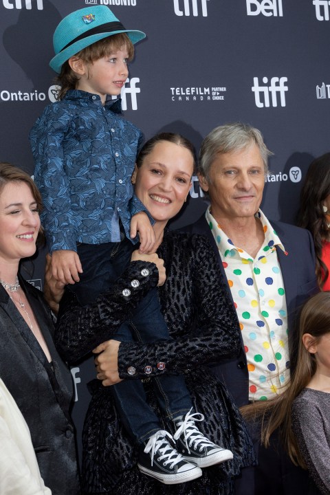 Vicky Krieps holds Atlas Green in her arms as Viggo Mortensen, right and Veronique Chaumont look on, as they attend the premiere of "The Dead Don't Hurt" at the Princess of Wales Theatre during the Toronto International Film Festival, Friday, Sept. 8, 2023, in Toronto. (Photo by Joel C Ryan/Invision/AP)