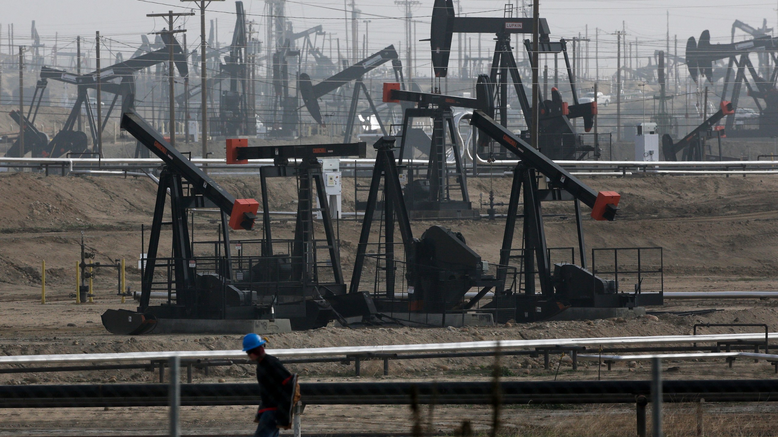 FILE - Pumpjacks operating at the Kern River Oil Field are seen in Bakersfield, Calif., on Jan. 16, 2015. The state of California has filed a lawsuit against some of the world's largest oil and gas companies, claiming they deceived the public about the risks of fossil fuels blamed for climate change-related storms and wildfires that caused billions of dollars in damage. (AP Photo/Jae C. Hong, File)