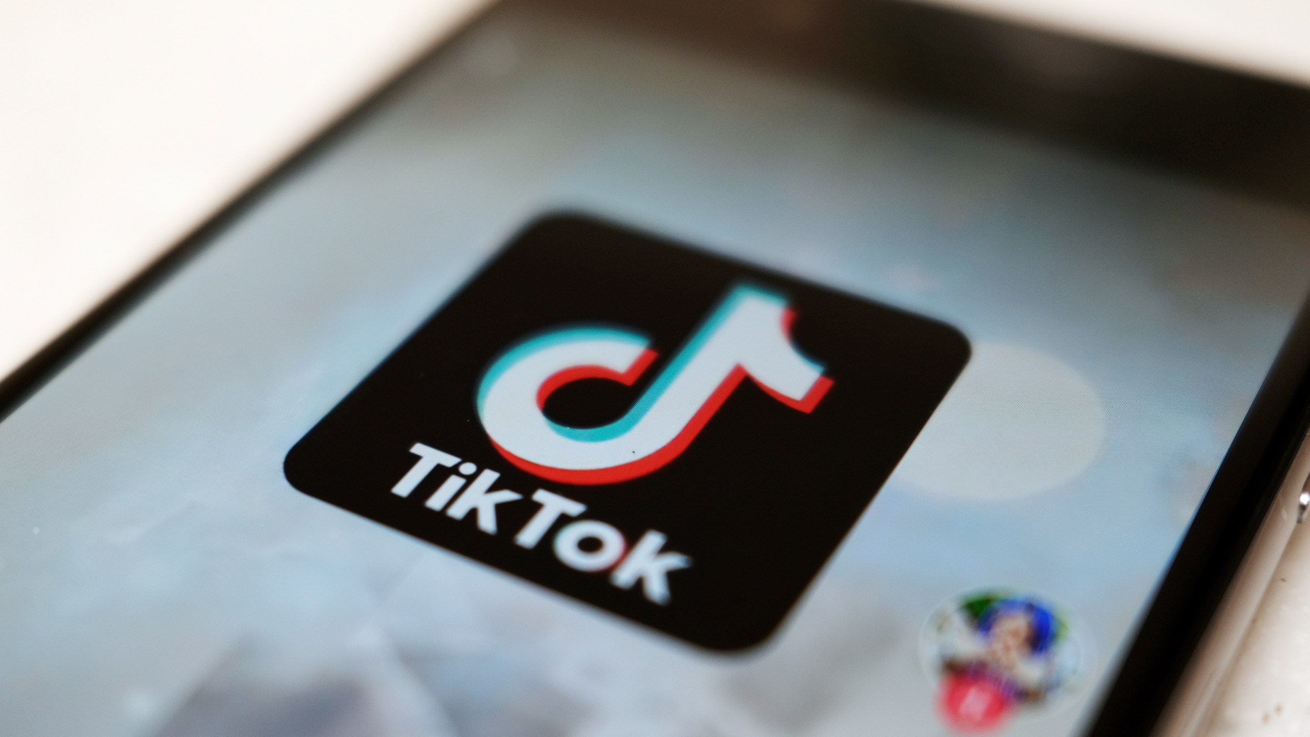 FILE - The TikTok logo is displayed on a smartphone screen in Tokyo on Sept. 28, 2020. TikTok said on Tuesday, Sept. 19, 2023, that it will begin launching a new tool that will help creators label AI-generated content they produce. (AP Photo/Kiichiro Sato, File)