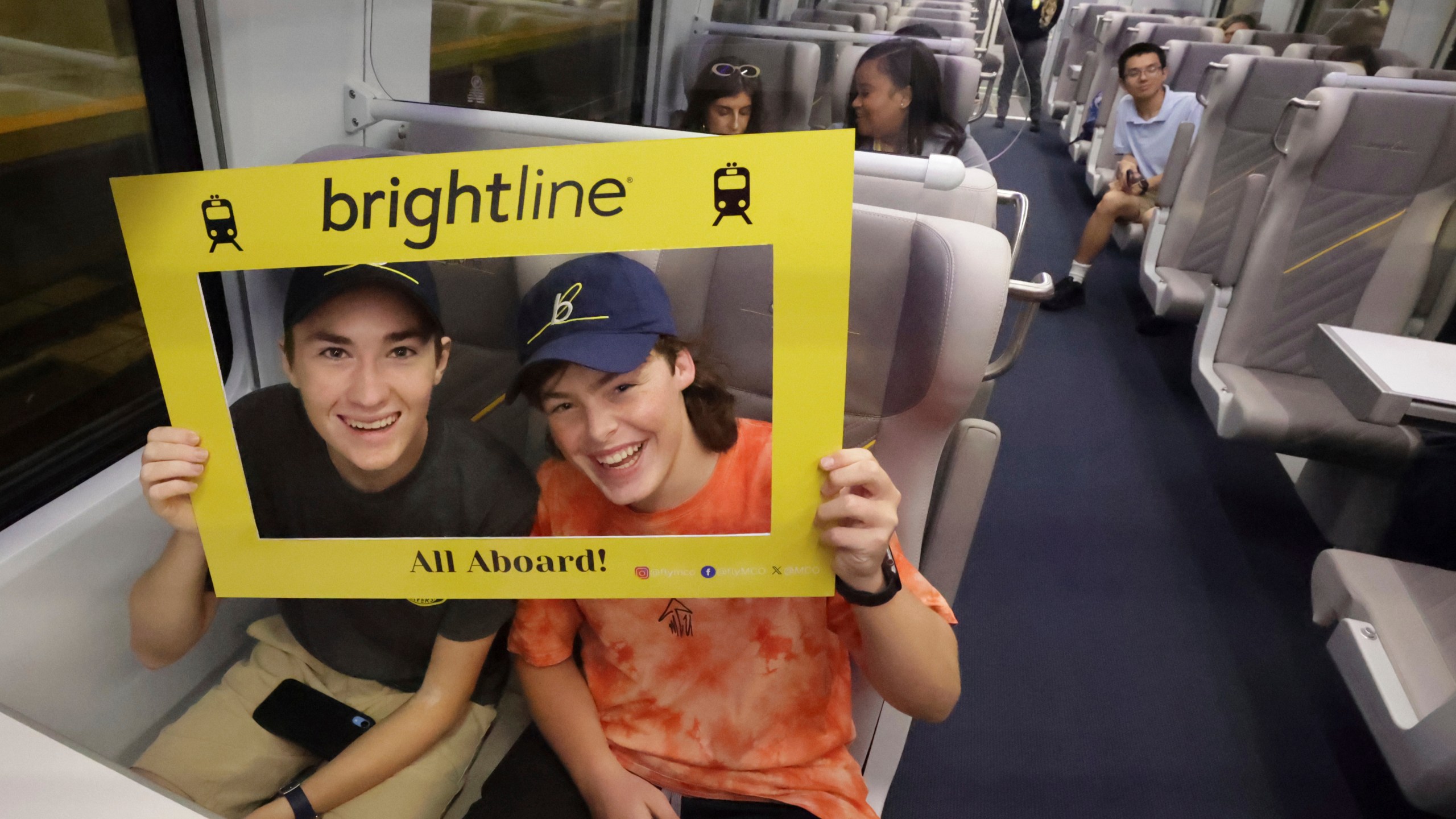 Passengers celebrate as the first Brightline train to Miami for the debut of service from Orlando International Airport pulls out of the station, early Friday, Sept. 22, 2023. The high-speed Orlando-Miami route marks first new privately-owned inter-city passenger service to roll out in the U.S. in 100 years. (Joe Burbank /Orlando Sentinel via AP)