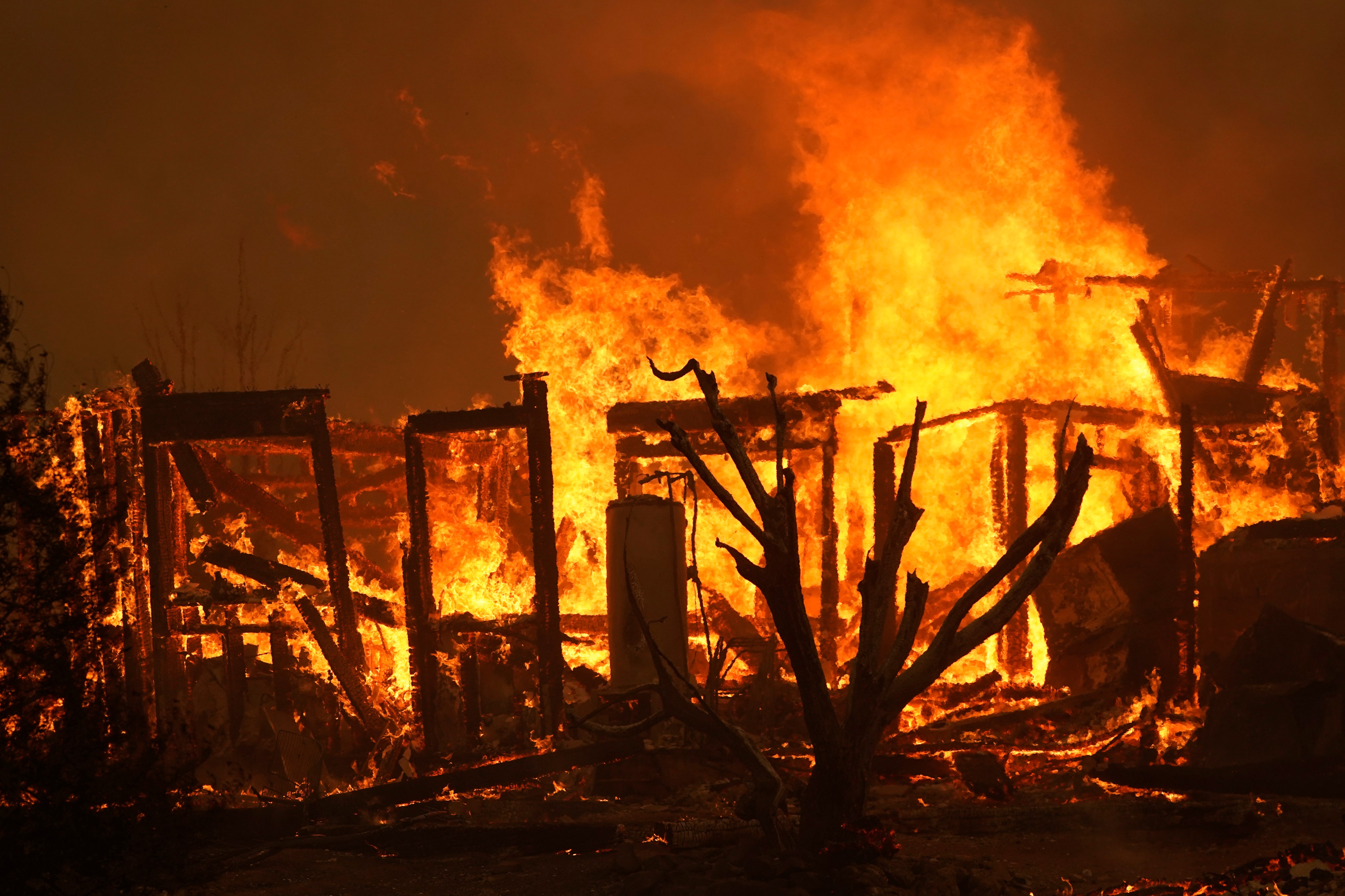 A home burns along Cima Mesa Rd. as the Bobcat Fire advances Friday, Sept. 18, 2020, in Juniper Hills, Calif. (AP Photo/Marcio Jose Sanchez)