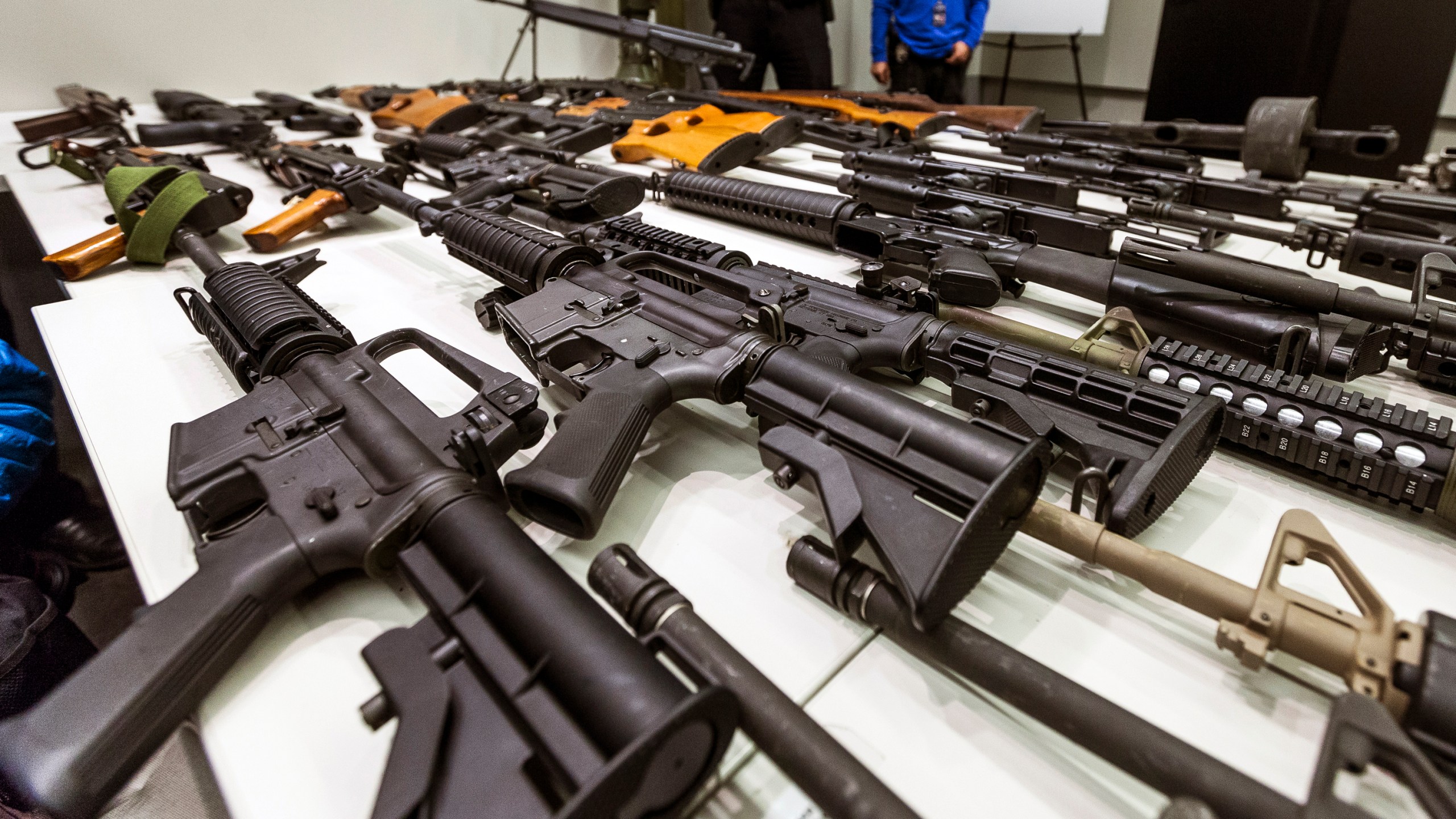 A variety of military-style semi-automatic rifles obtained during a buy back program are displayed at Los Angeles police headquarters on Dec. 27, 2012. (Damian Dovarganes/Associated Press)