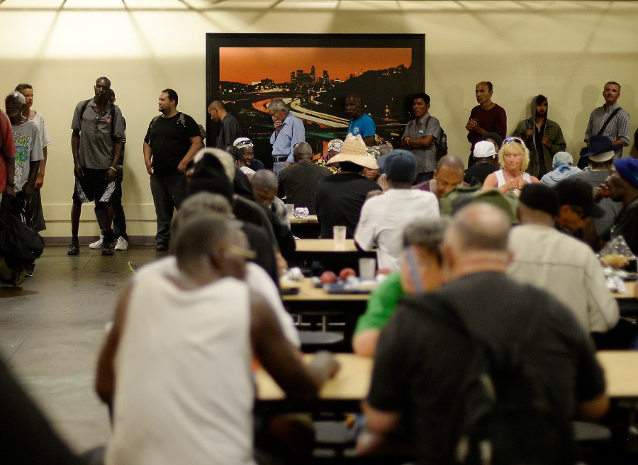 Homeless men and women wait in line to receive food at The Midnight Mission on September 23, 2015, in Los Angeles, California. (Getty Images)