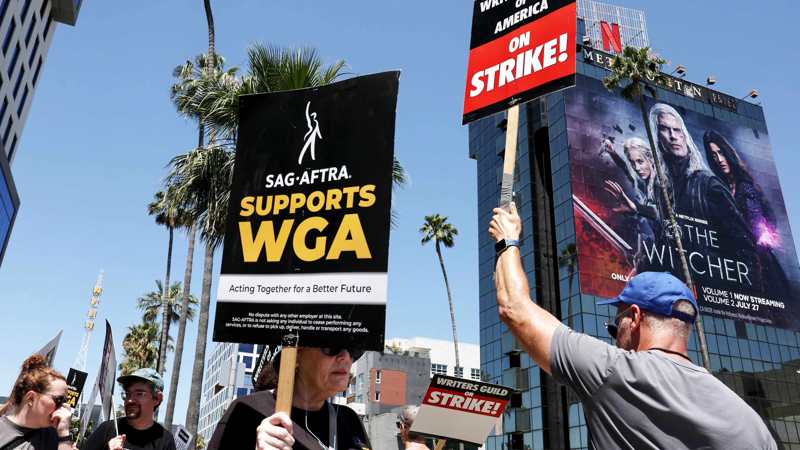 A sign reads "SAG-AFTRA Supports WGA" as SAG-AFTRA members walk the picket line in solidarity with striking WGA workers outside Netflix offices on July 11, 2023, in Los Angeles. (Mario Tama/Getty Images)