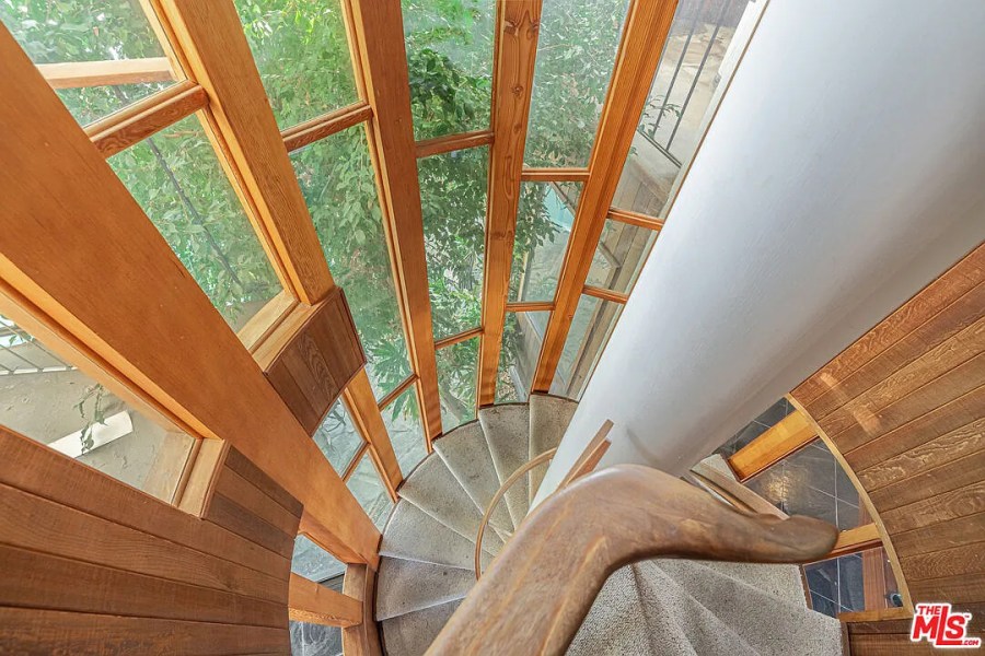 The home features delicate and artful woodworking, including a spiral staircase (AVOH)