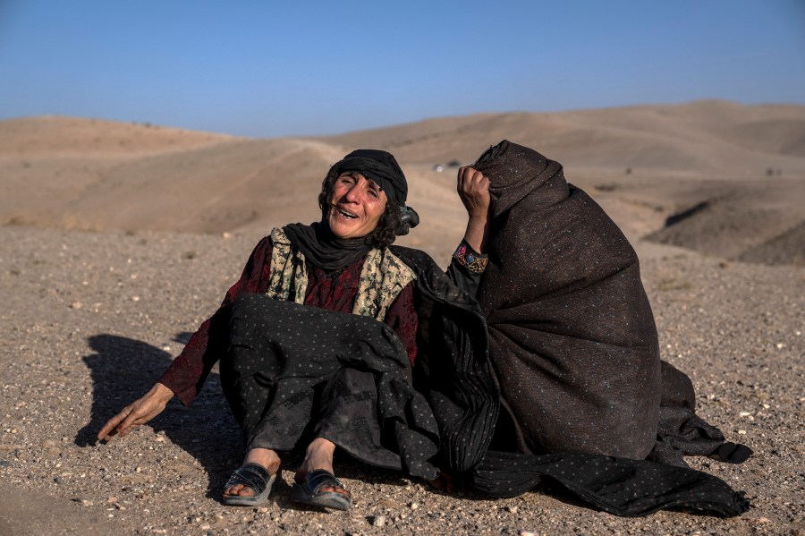 Afghan women mourn relatives killed in an earthquake at a burial site after an earthquake in Zenda Jan district in Herat province, western of Afghanistan, Sunday, Oct. 8, 2023. Powerful earthquakes killed at least 2,000 people in western Afghanistan, a Taliban government spokesman said Sunday. It's one of the deadliest earthquakes to strike the country in two decades. (AP Photo/Ebrahim Noroozi)