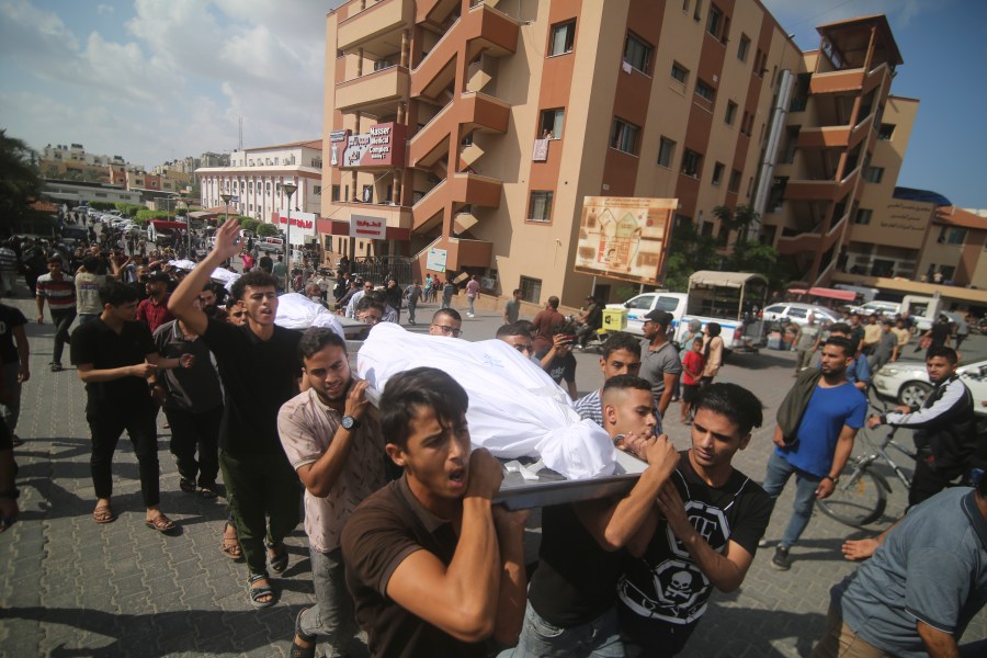 Palestinians carry bodies from the Abu Rayash family killed in Israeli shelling during their funeral in Rafah, Gaza Strip, Thursday, Oct. 12, 2023. (AP Photo/Hatem Ali)