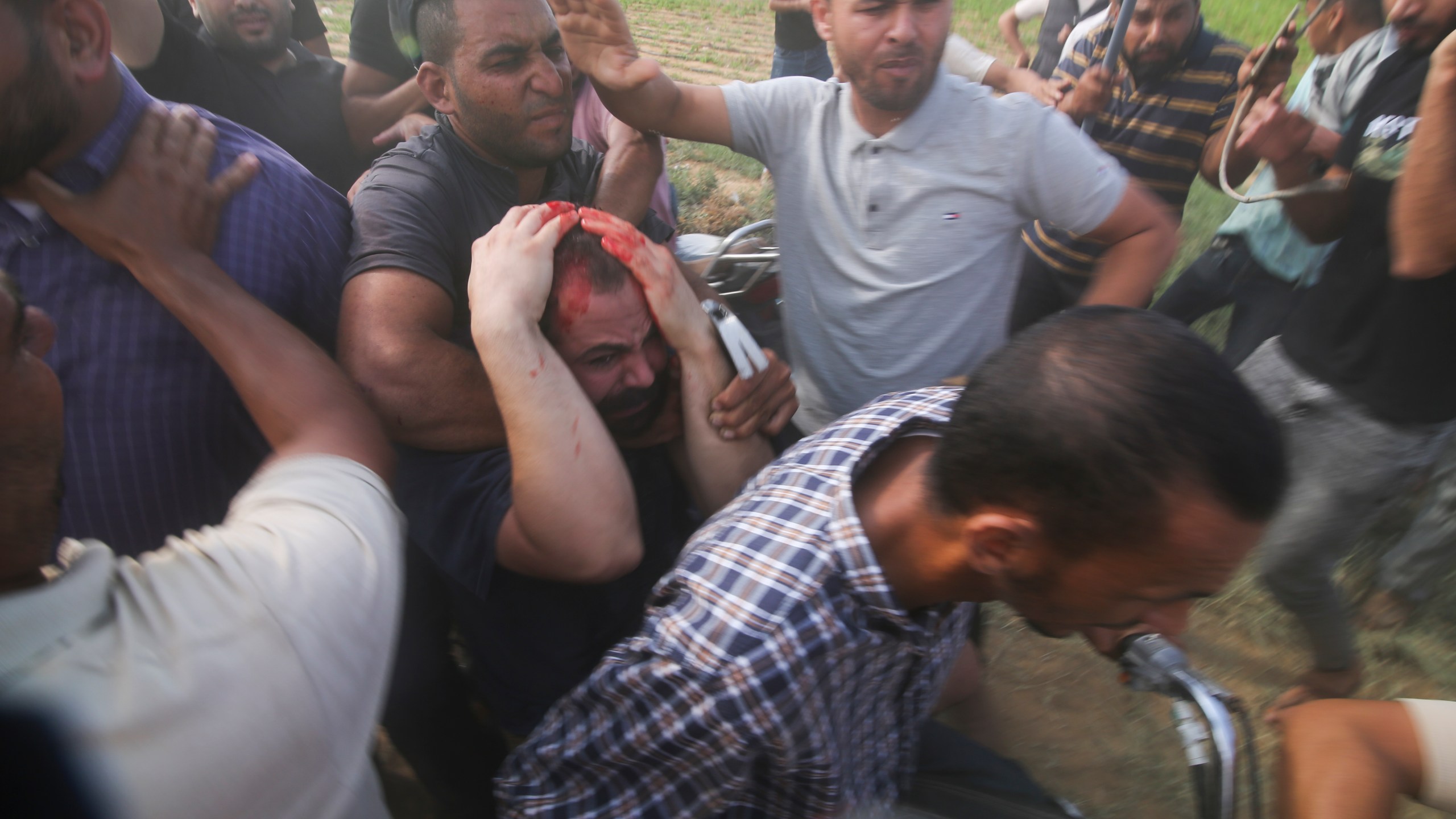 FILE - Palestinians transport a captured Israeli civilian, center, from Kibbutz Kfar Azza into the Gaza Strip on Saturday, Oct. 7, 2023. Israel's military brought together a group of foreign correspondents Monday, Oct. 16, to screen a 40-minute reel of gruesome footage compiled from the Hamas attack last week. The screening came as Israel's military faces increasing pressure to back up their claims of atrocities committed by the militants. (AP Photo/Hatem Ali, File)