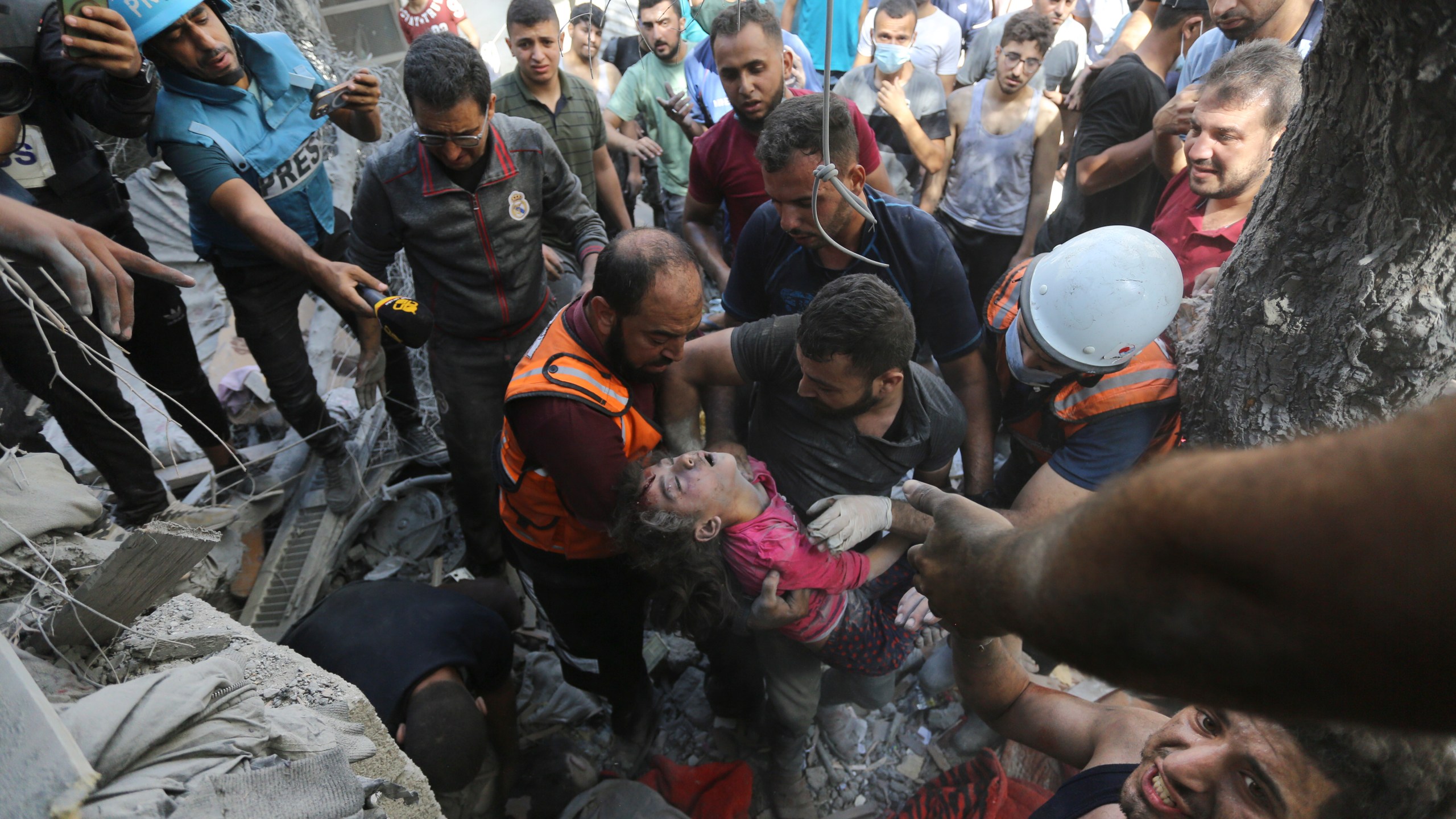 CORRECTS DATE Palestinians rescue a child from under the rubble after Israeli airstrikes in Gaza City, Gaza Strip, Wednesday, Oct. 18, 2023. (AP Photo/Abed Khaled)