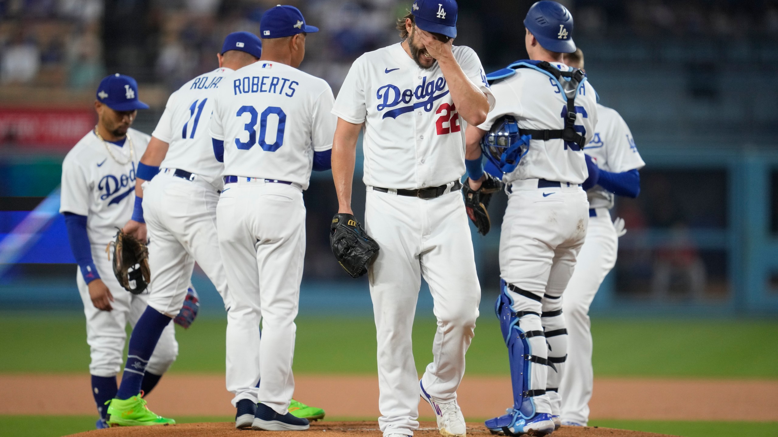 Los Angeles Dodgers starting pitcher Clayton Kershaw, center, reacts as he exits during the first inning in Game 1 of a baseball NL Division Series against the Arizona Diamondbacks, Saturday, Oct. 7, 2023, in Los Angeles. (AP Photo/Ashley Landis)