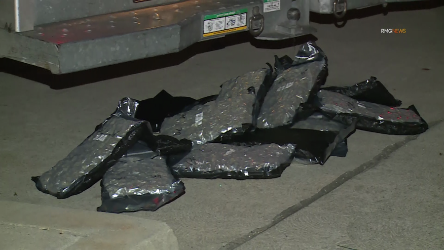 Vacuum-sealed bags of reported marijuana are seen laying on the ground near a U-Haul truck that crashed on Oct. 26, 2023. (RMG News)