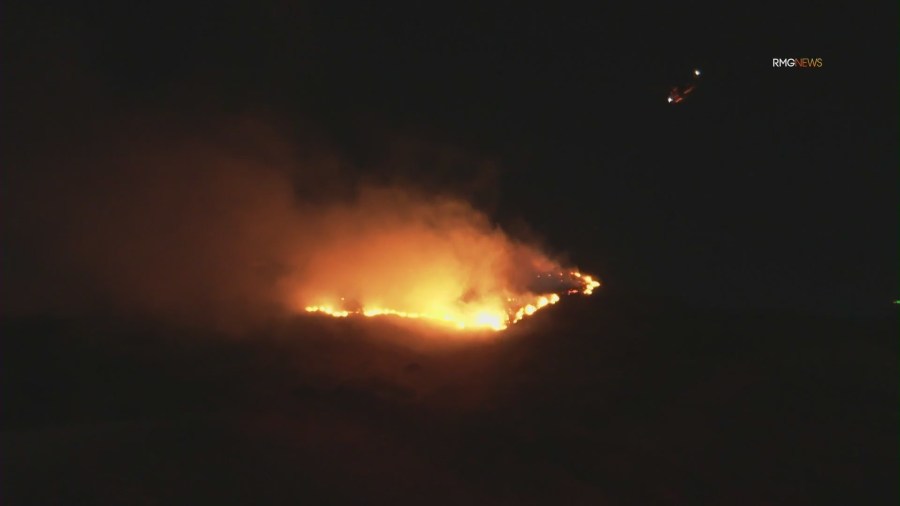 Fire crews work to contain overnight brush fire in San Fernando Valley amid Santa Ana winds 