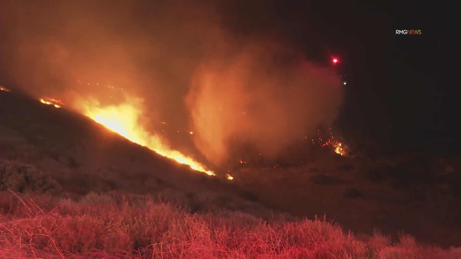 Fire crews work to contain overnight brush fire in San Fernando Valley amid Santa Ana winds