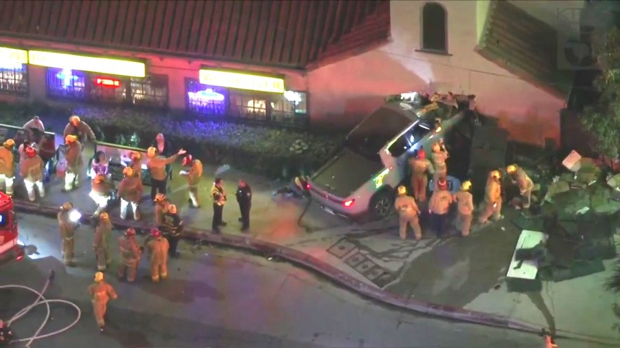 At least one person is hospitalized after a three-vehicle collision sent a truck crashing through a pizza shop in Hollywood on Oct. 31, 2023. (KTLA)