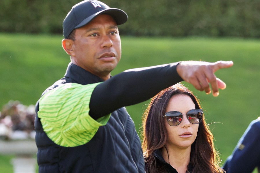 FILE - Tiger Woods, left, and Erica Herman appear on the 18th green during the JP McManus Pro-Am at Adare Manor, Limerick, Ireland, July, 4, 2022. Herman, the ex-girlfriend of golf superstar Woods, has dropped her $30 million lawsuit against the trust that owns his $54 million Florida mansion. (AP Photo/Peter Morrison, File)