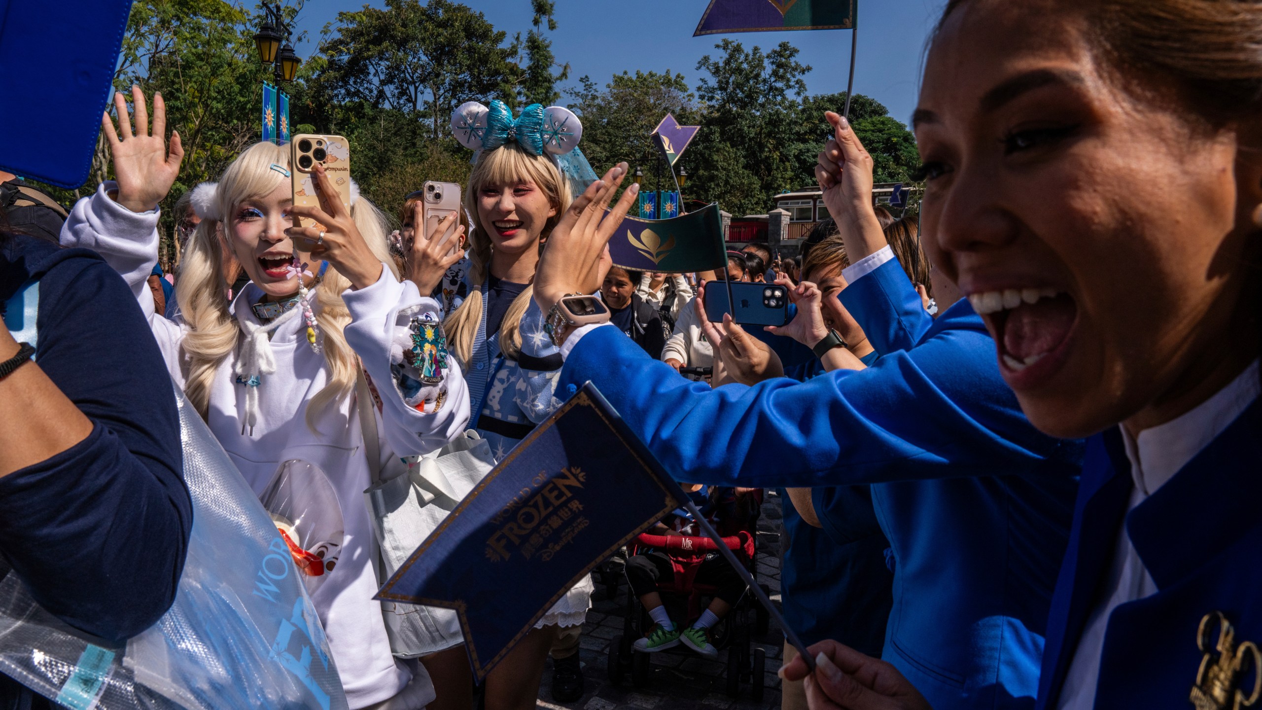 Visitors arrive the World of Frozen themed area during its opening ceremony at Disneyland Resort in Hong Kong, Monday, Nov. 20, 2023. (AP Photo/Louise Delmotte)