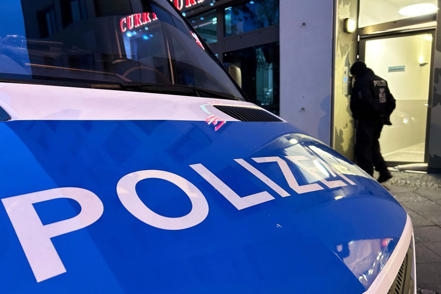 A police vehicle stands on the street during a raid in Berlin-Adlershof in Berlin, Thursday, Nov. 23, 2023. Hundreds of police officers searched the properties of Hamas members and followers in Germany on Thursday morning with the majority of the raids taking place in Berlin.(Sven Kaeuler/dpa via AP)