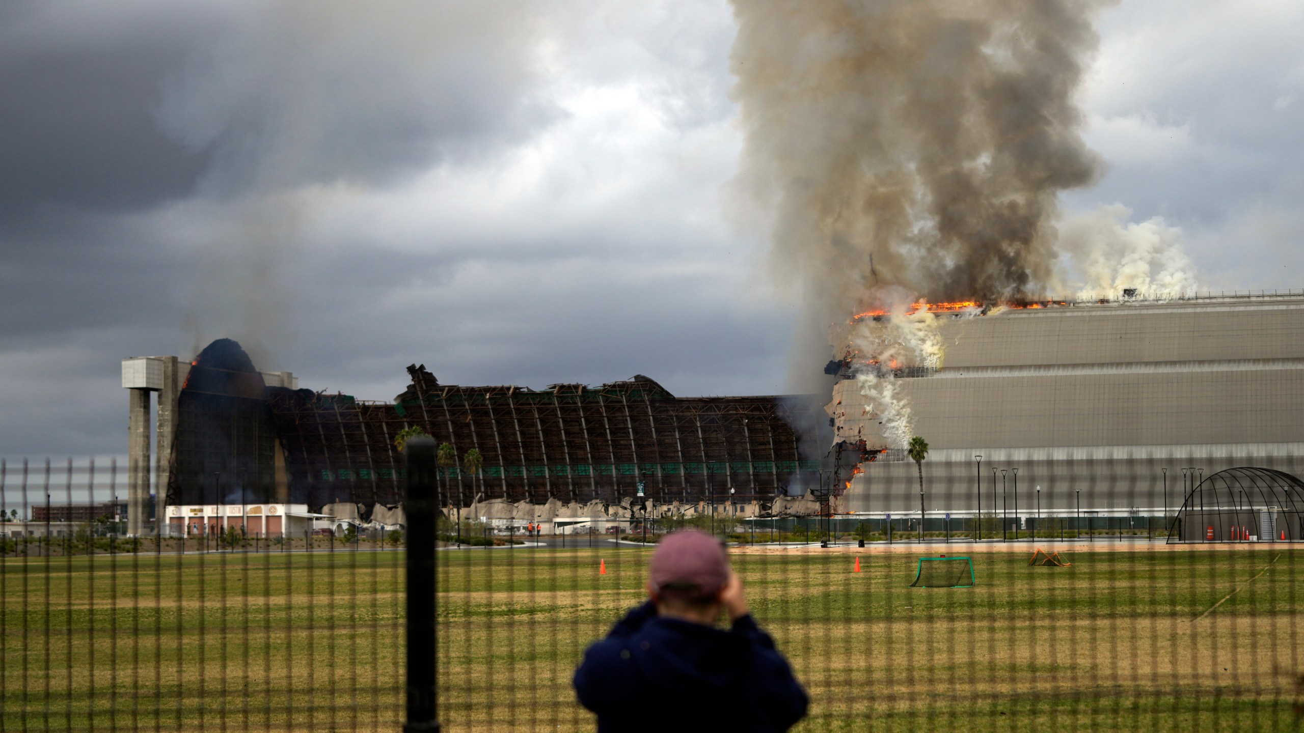 A historic blimp hangar burns in Tustin, Calif., Tuesday, Nov. 7, 2023. A fire destroyed a massive World War II-era wooden hangar that was built to house military blimps based in Southern California. (AP Photo/Jae C. Hong)