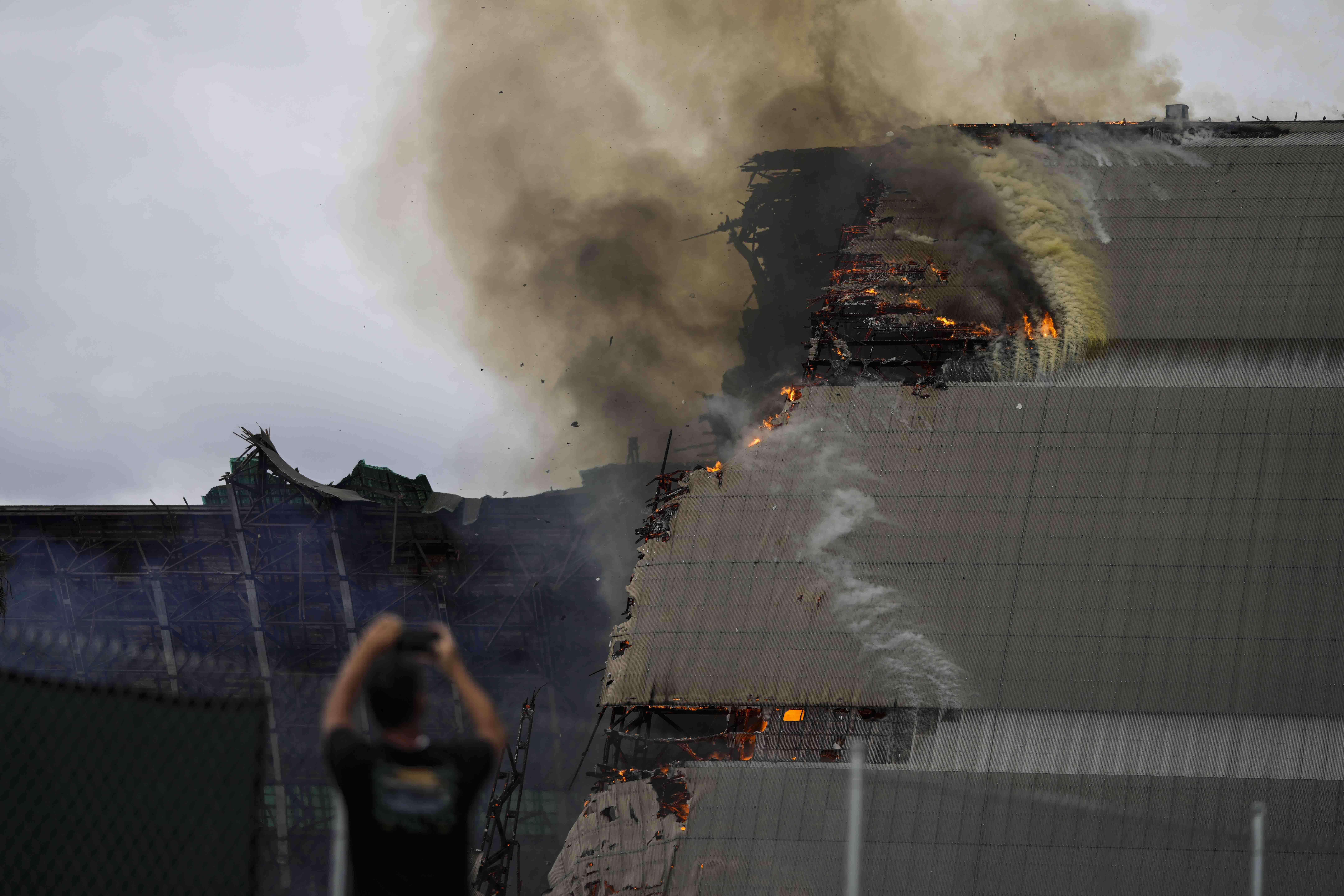 A historic blimp hangar burns in Tustin, Calif., Tuesday, Nov. 7, 2023. A fire destroyed a massive World War II-era wooden hangar that was built to house military blimps based in Southern California. (AP Photo/Jae C. Hong)