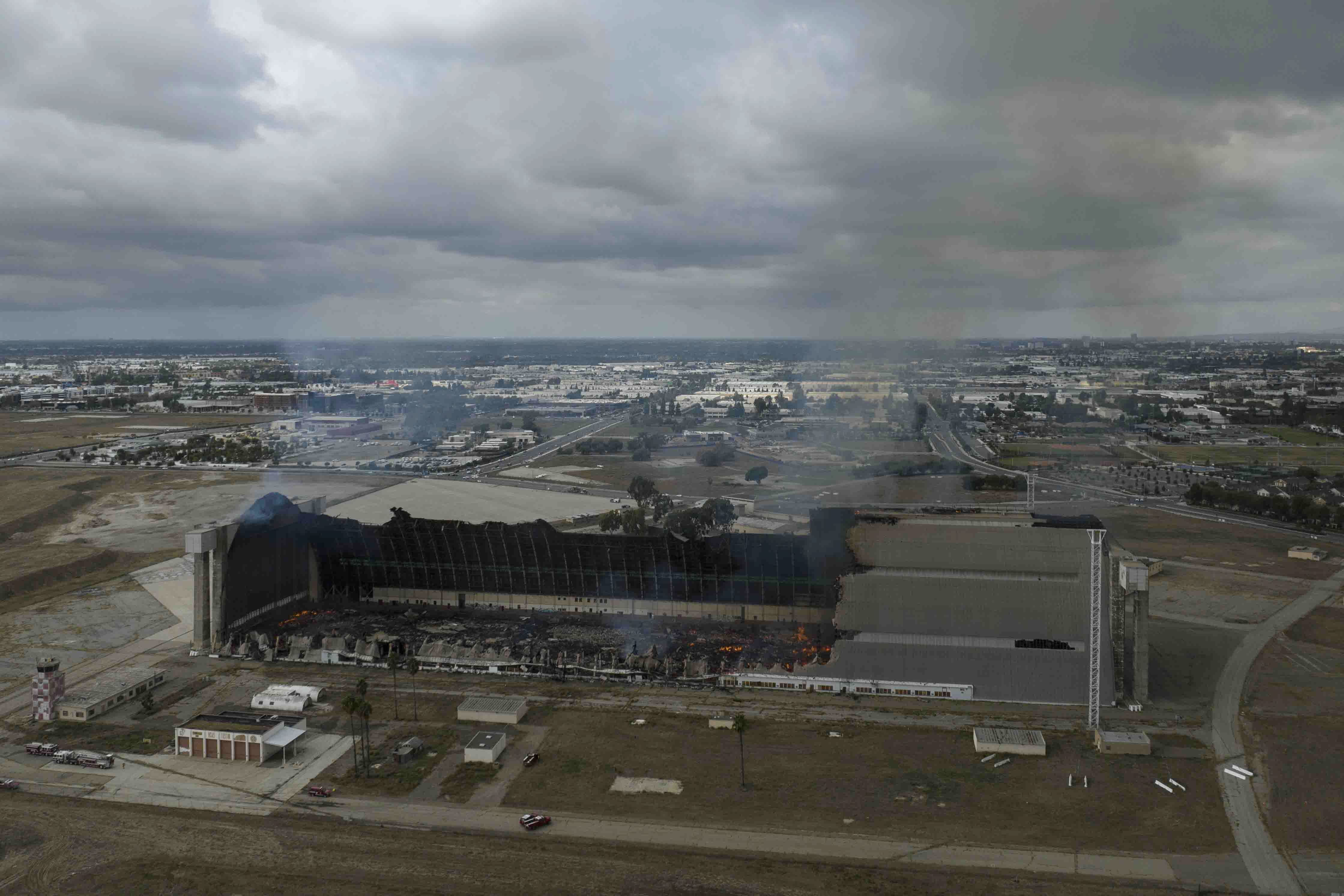 A historic blimp hangar burns in Tustin, Calif., Tuesday, Nov. 7, 2023. A fire destroyed a massive World War II-era wooden hangar that was built to house military blimps based in Southern California. (AP Photo/Jae C. Hong)