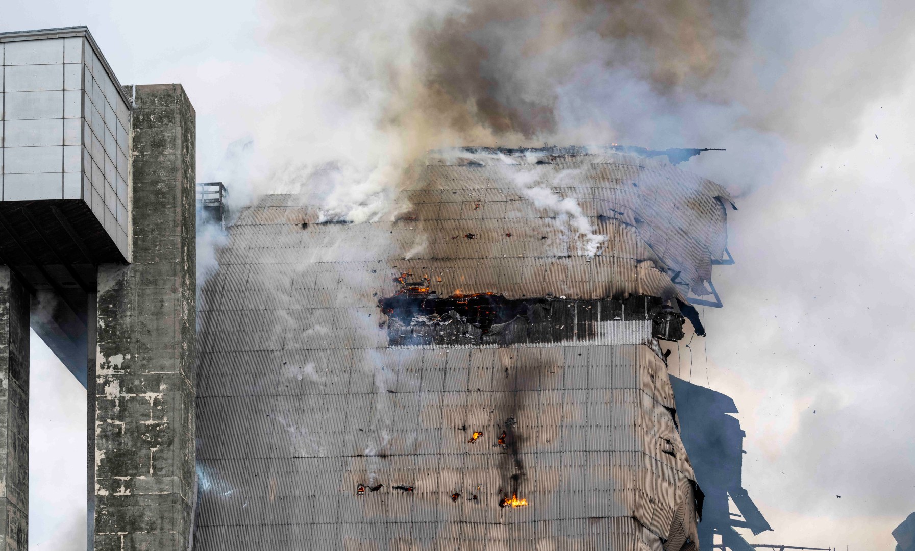 Orange County firefighters battle a fire affecting the north hangar at the Tustin Air Base in Tustin, Calif. Tuesday, Nov. 7, 2023. (Paul Bersebach/The Orange County Register via AP)