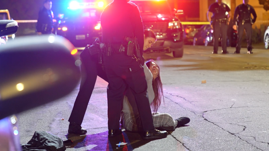 A woman is taken into custody in Koreatown.