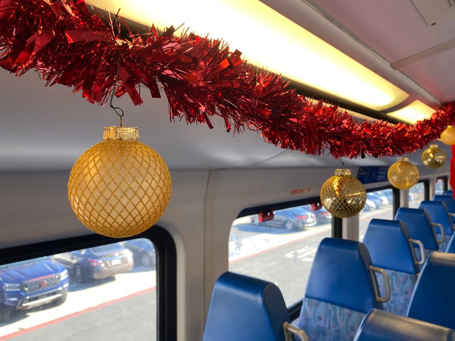 Ornaments hangs from the ceiling of a Metrolink train serving as the "Holiday Express" at Los Angeles Union Station on Nov. 21, 2023. (KTLA)