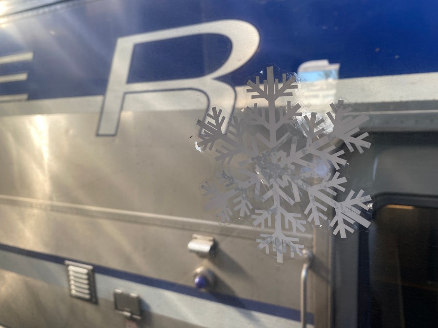 Snowflake stickers are shown on the windows of Metrolink train serving as the "Holiday Express," on Nov. 21, 2023. (KTLA)