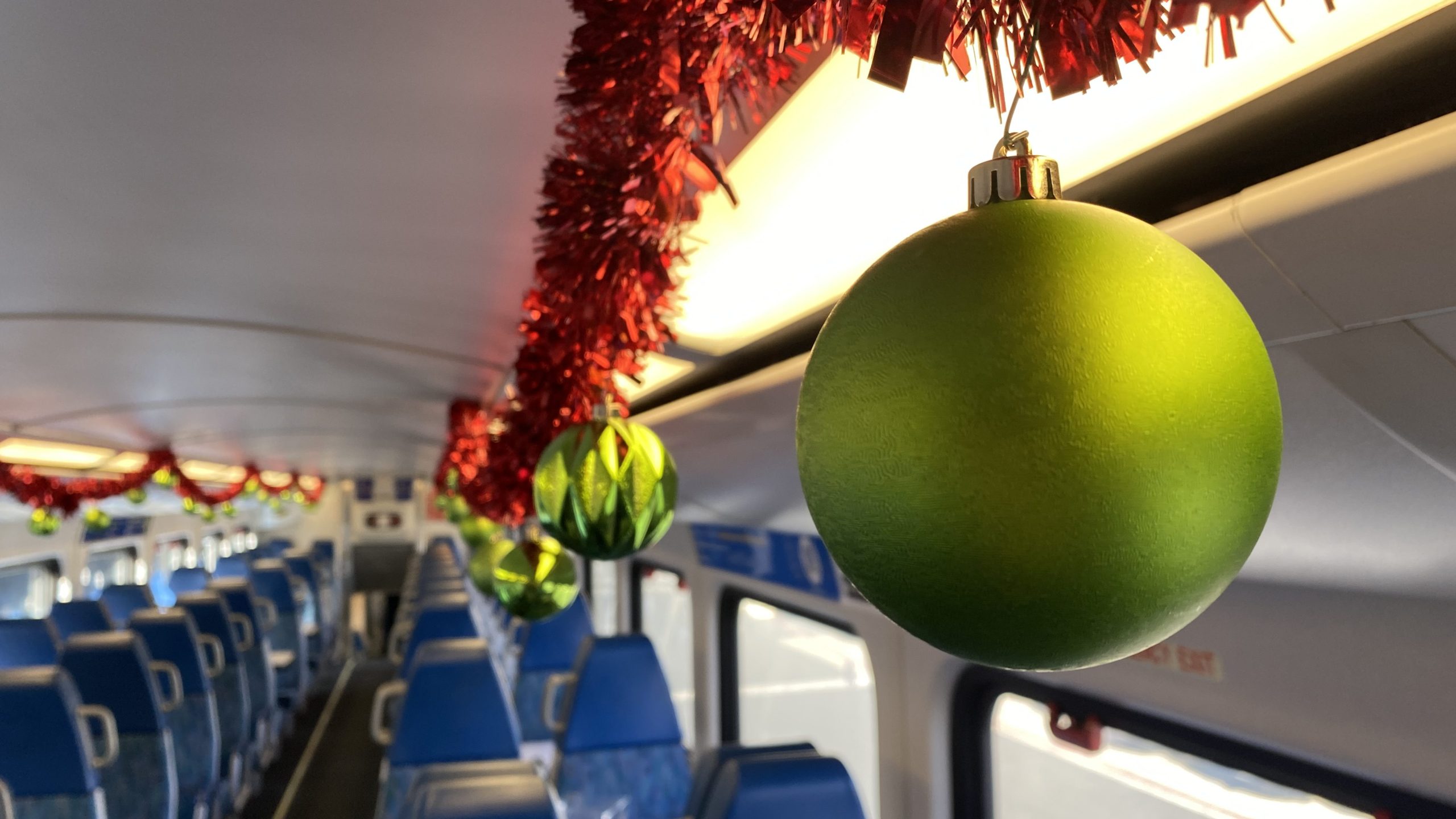 Ornaments hangs from the ceiling of a Metrolink train serving as the "Holiday Express" at Los Angeles Union Station on Nov. 21, 2023. (KTLA)