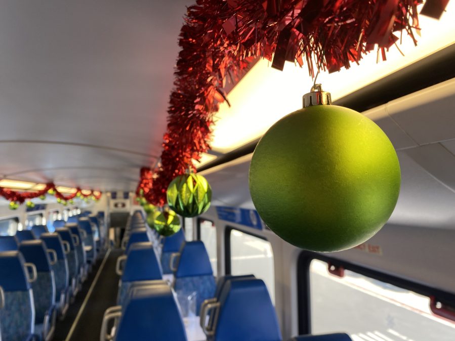 Ornaments hangs from the ceiling of a Metrolink train serving as the "Holiday Express" at Los Angeles Union Station on Nov. 21, 2023. (KTLA)