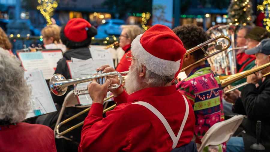 A musician wearing a Santa Claus hat plays during Julefest 2022 in Solvang, California. (Mike Laan/City of Solvang)