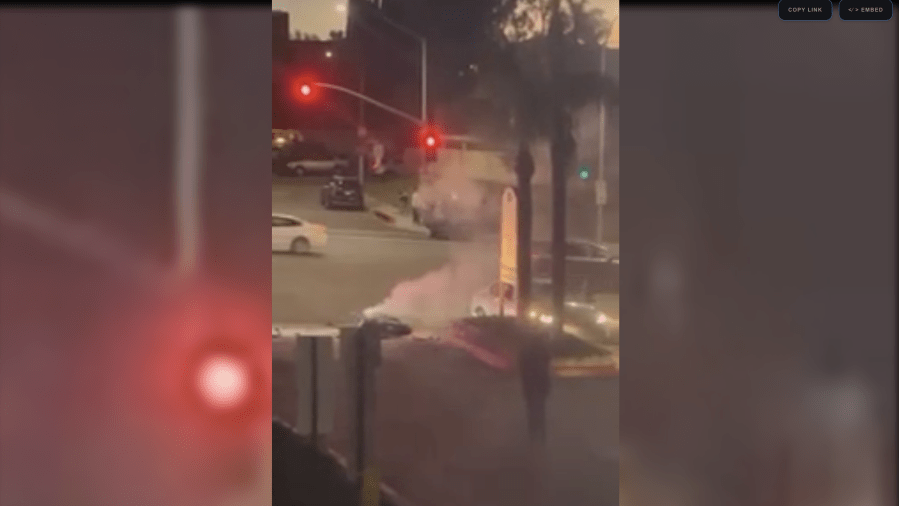 Smoke billows from a motorcycle lying at the scene of a fatal crash in West Covina on Nov. 23, 2023 as seen in a video posted to the Citizen App. 