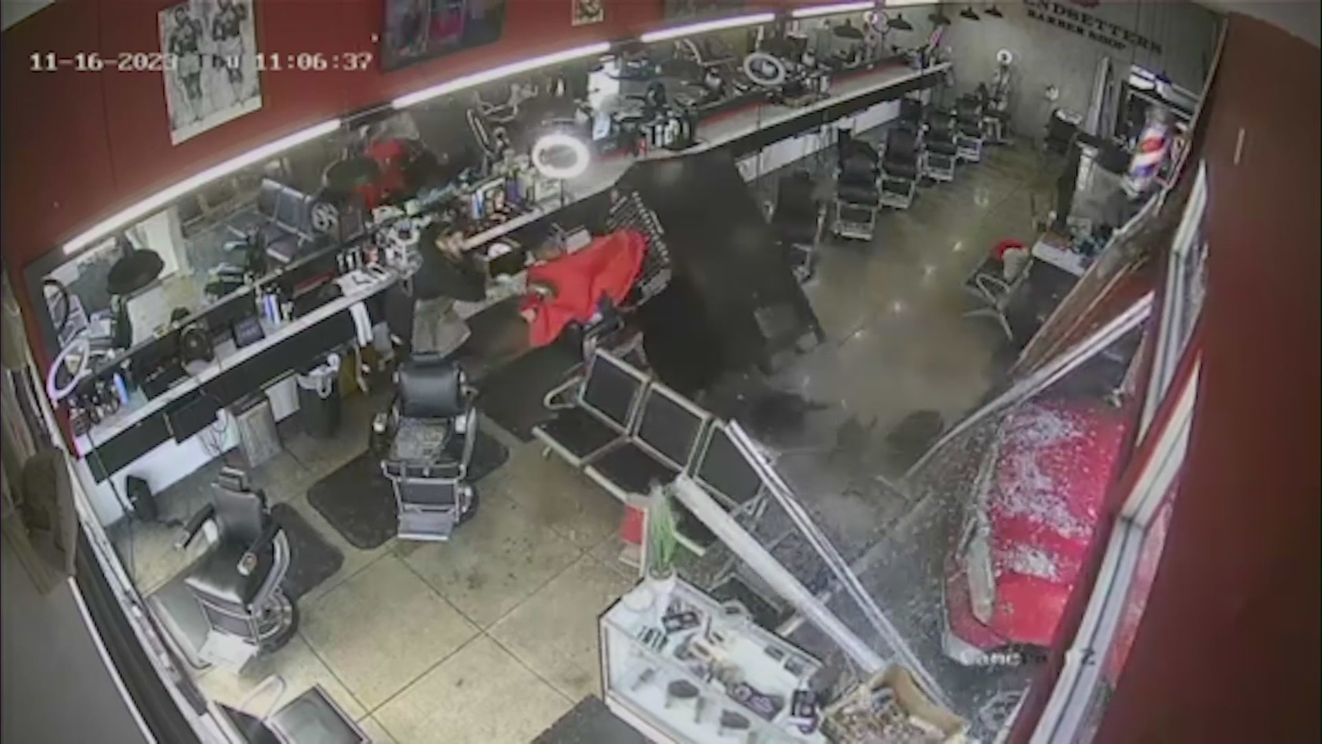 Surveillance video captures the frightening moment a pickup truck crashes through a West Hollywood barber shop, narrowly missing customers inside on Nov. 16, 2023. (Trendsetters Barbershop)
