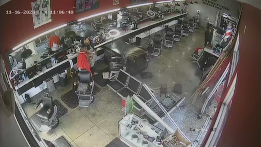 Surveillance video captures the frightening moment a pickup truck crashes through a West Hollywood barber shop, narrowly missing customers inside on Nov. 16, 2023. (Trendsetters Barbershop)