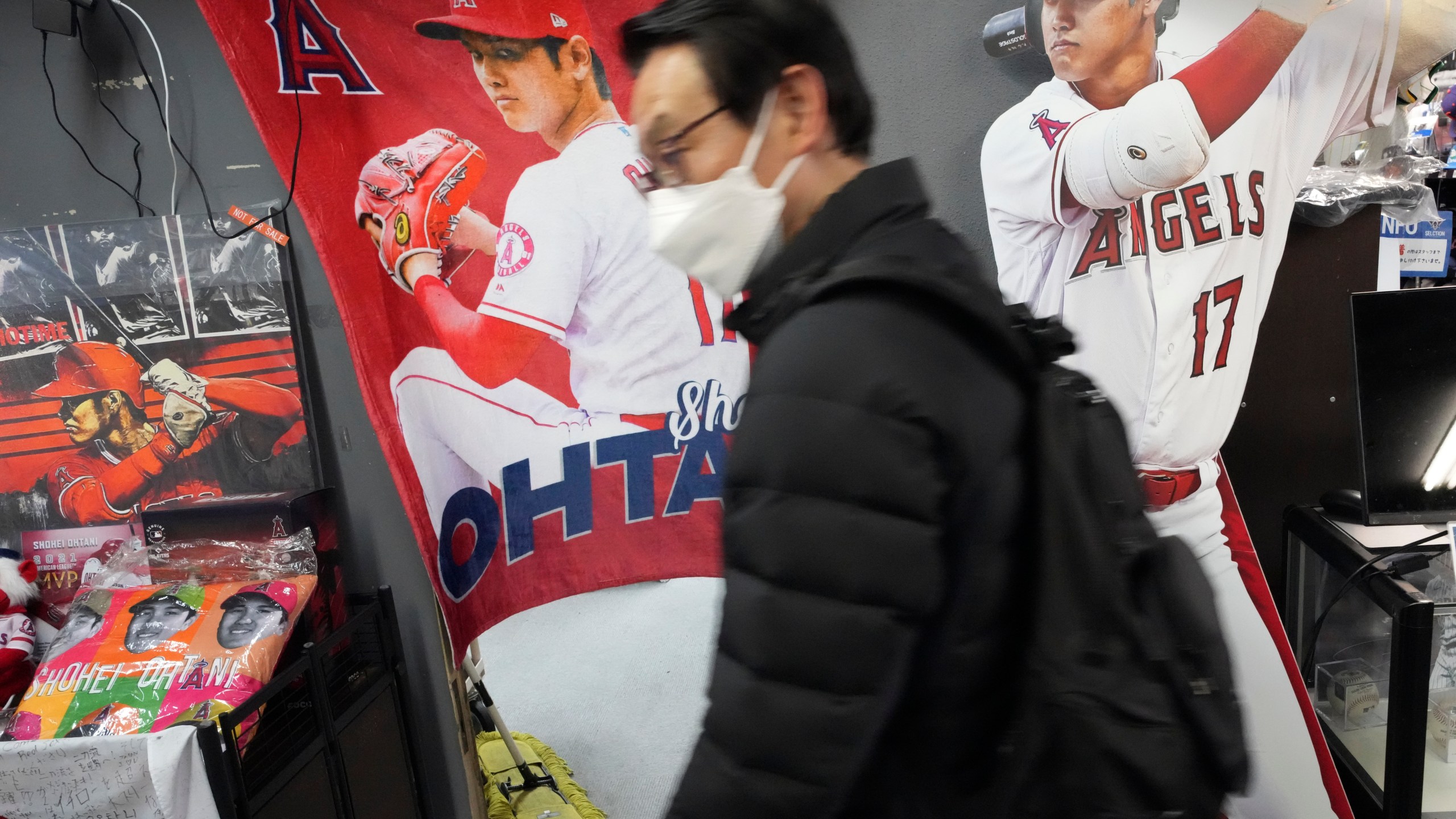 Customers shop around for character goods of Shohei Ohtani of the Los Angeles Dodgers at a sporting goods store, "SELECTION," in Shinjuku district Wednesday, Dec. 13, 2023, in Tokyo. Ohtani agreed to a record $700 million, 10-year contract with the Los Angeles Dodgers. (AP Photo/Eugene Hoshiko)