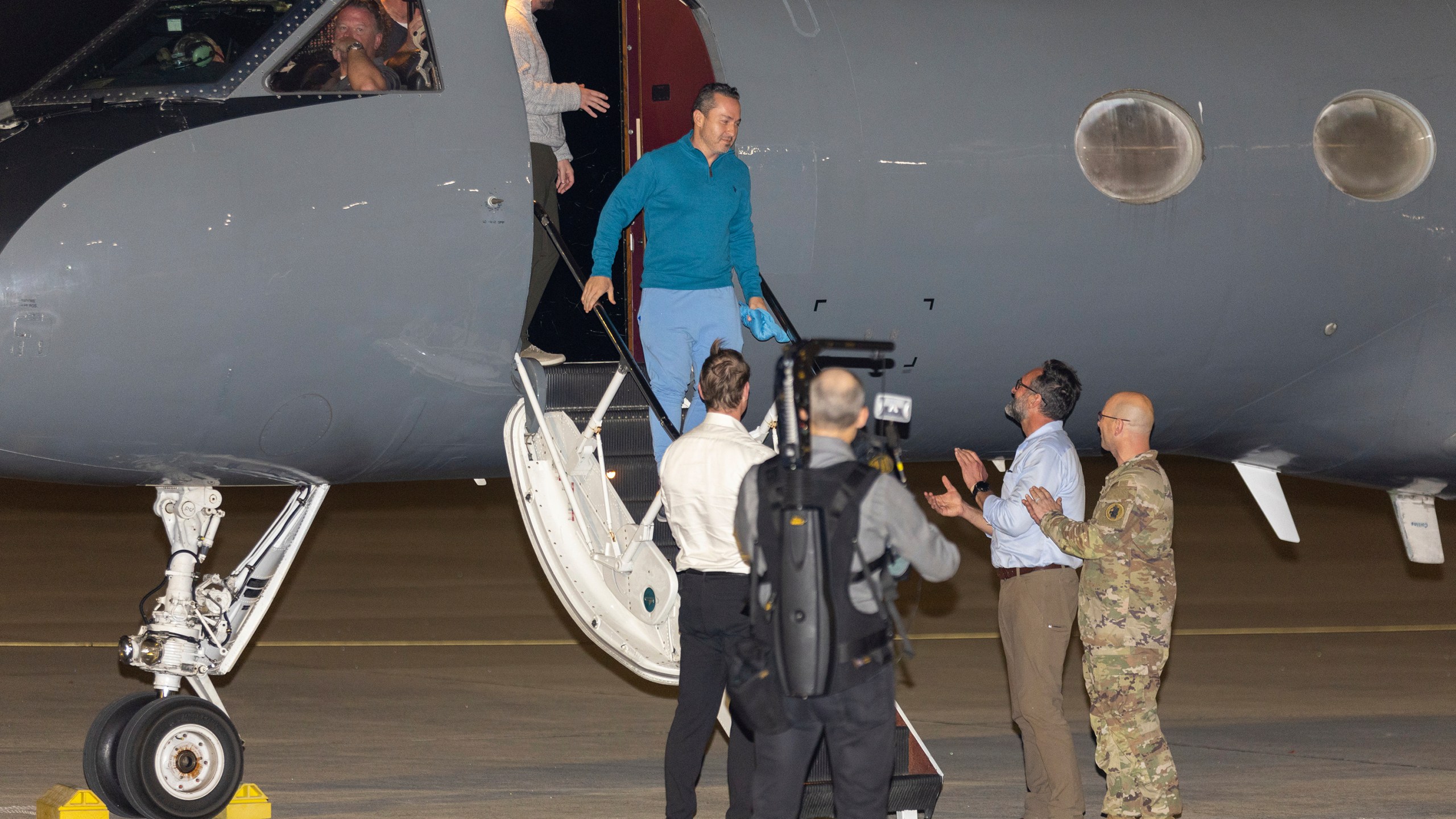 Freed American Eyvin Hernandez exits a State Department plane after he and nine fellow detainees were released in a prisoner swap deal between U.S. and Venezuela at Kelly Airfield Annex, Wednesday, Dec. 20, 2023, in San Antonio, Texas. Six of the Americans released arrived at Kelly Airfield Annex. (AP Photo/Stephen Spillman)