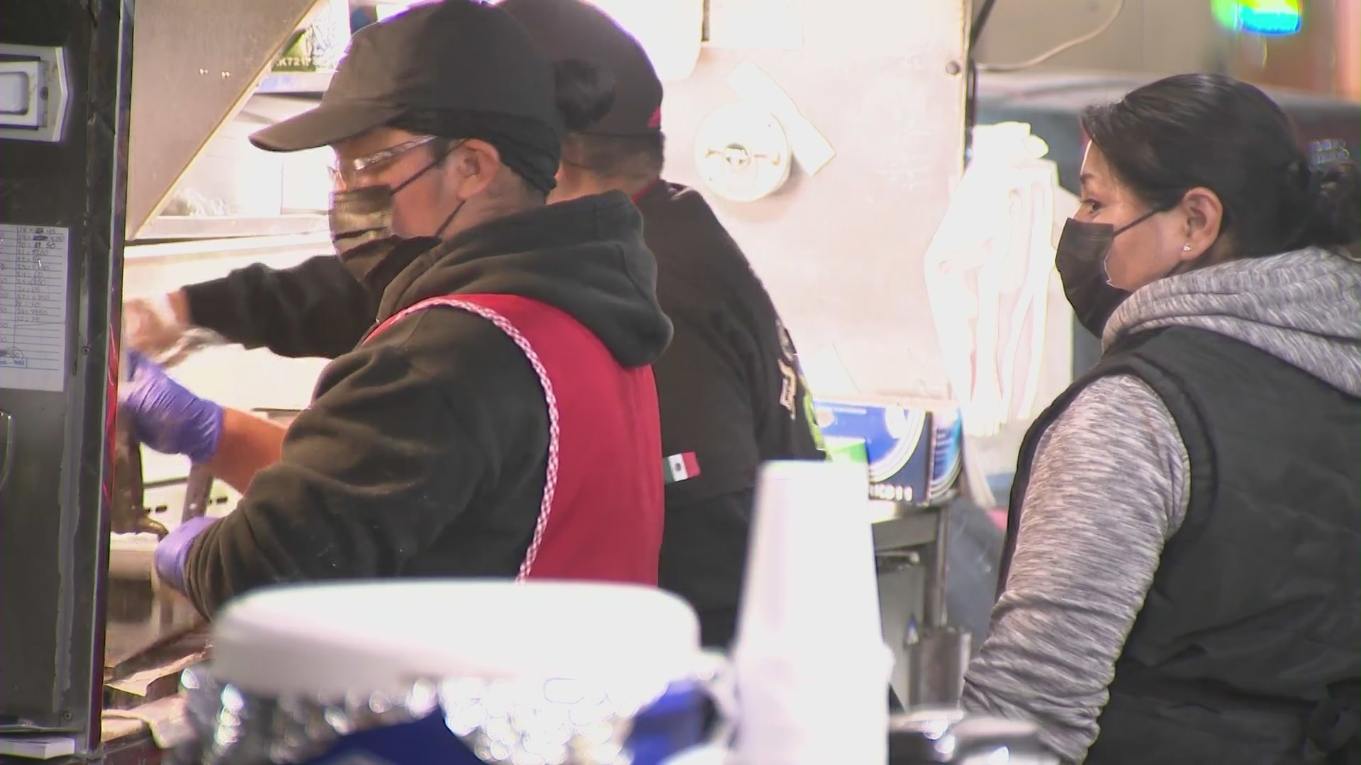 Workers at the Tacos El Caguamo stand in South Los Angeles. (KTLA)