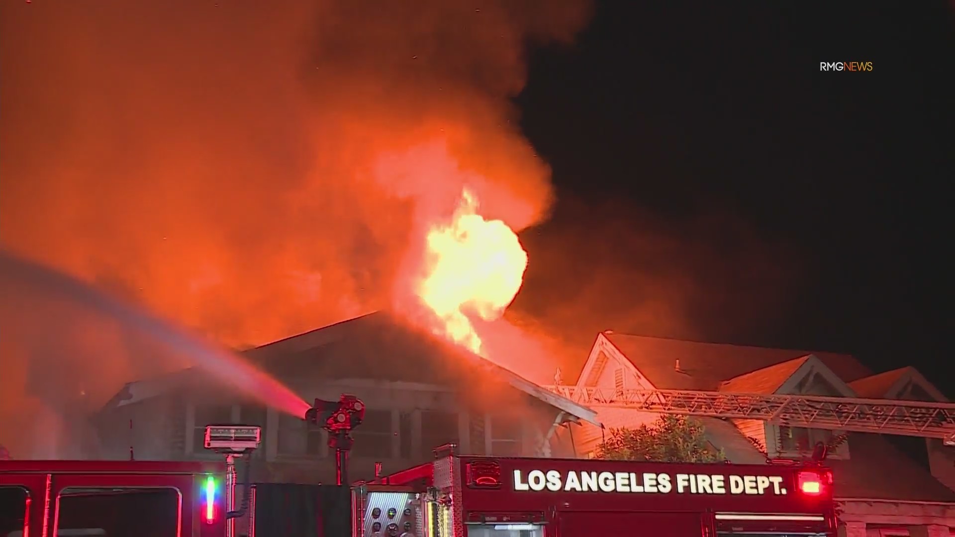 Video: Fire crews scramble to safety as fireball bursts through roof of home