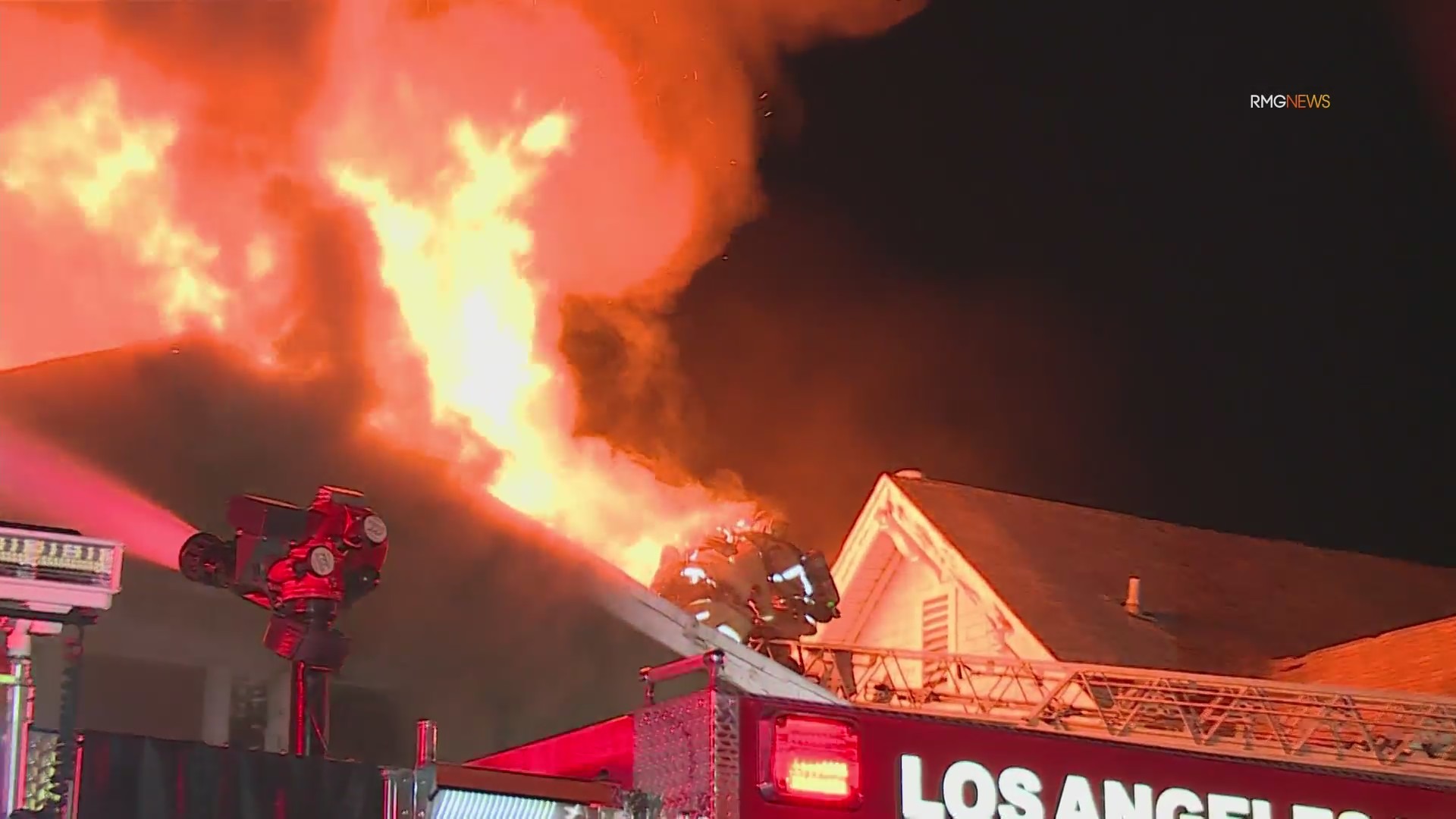 Video: Fire crews scramble to safety as fireball bursts through roof of home