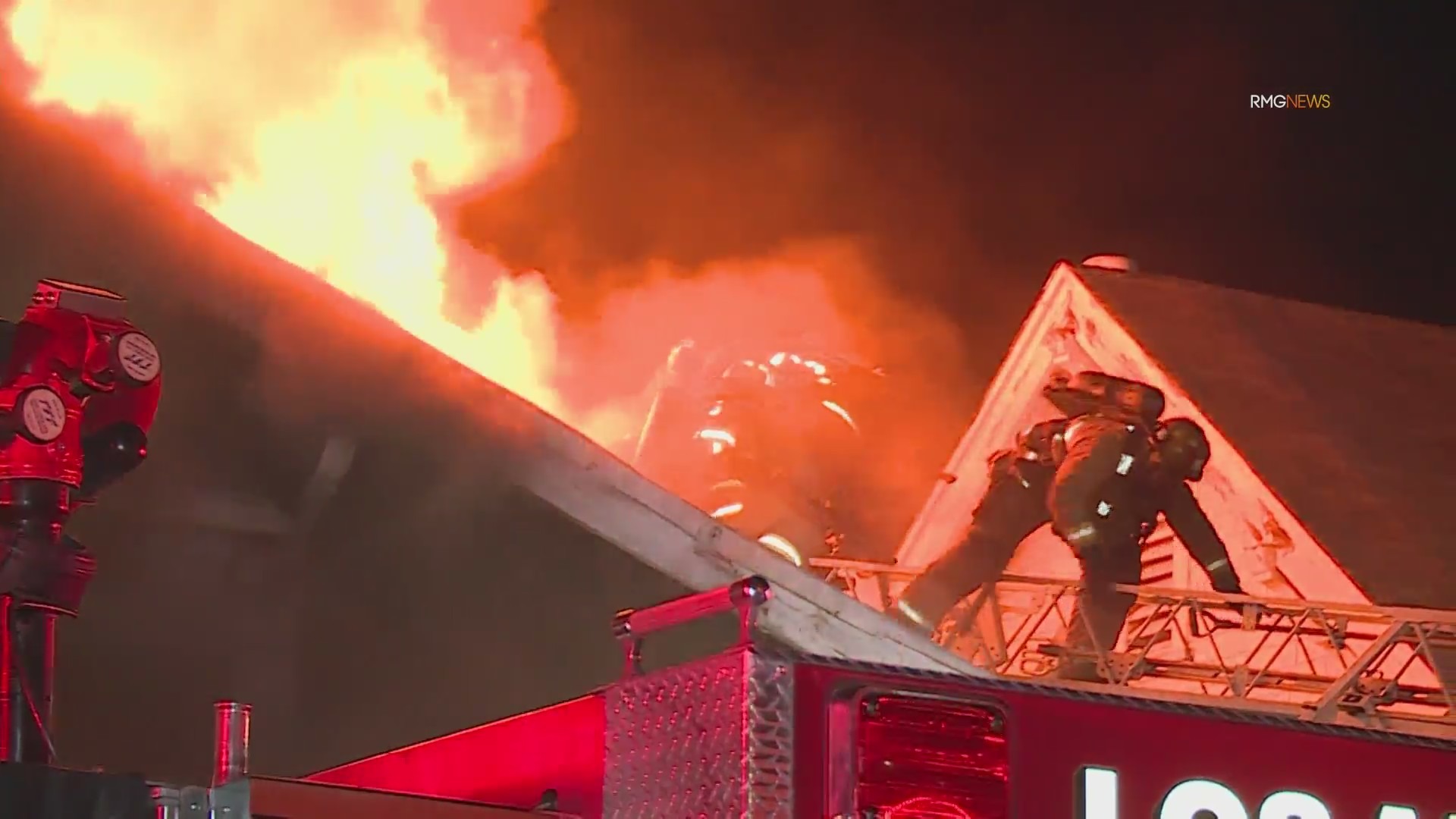 Video: Fire crews scramble to safety as fireball bursts through roof of home