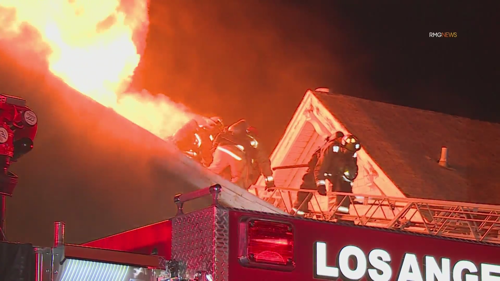 Video: Fire crews scramble to safety as fireball bursts through roof of home