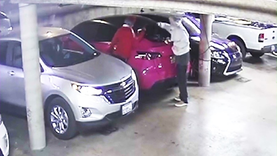 Surveillance footage of two suspects smashing an SUV's windows and stealing thousands of dollars worth of music equipment in a Hollywood parking garage on Dec. 18, 2023. (Louise Van Veenendaal)