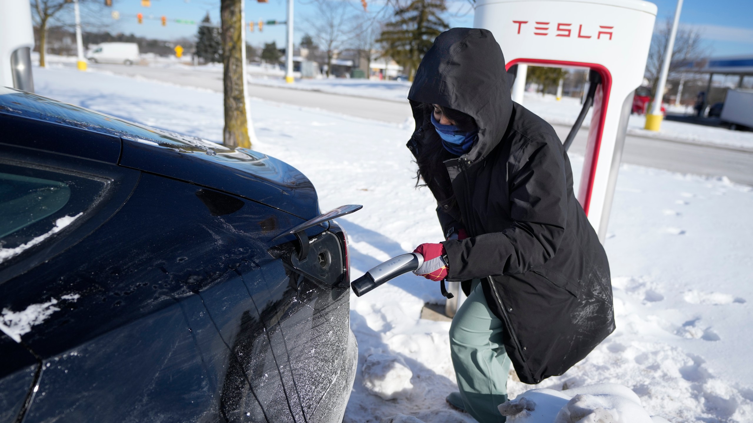 Ankita Bansal prepares to charge her Tesla, Wednesday, Jan. 17, 2024, in Ann Arbor, Mich. A subzero cold snap across the nation has exposed a big vulnerability for electric vehicle owners. It's difficult to charge the batteries in single-digit temperatures. Experts say it's simple chemistry, that the electrons move slowly and don't take in or release as much energy.(AP Photo/Carlos Osorio)