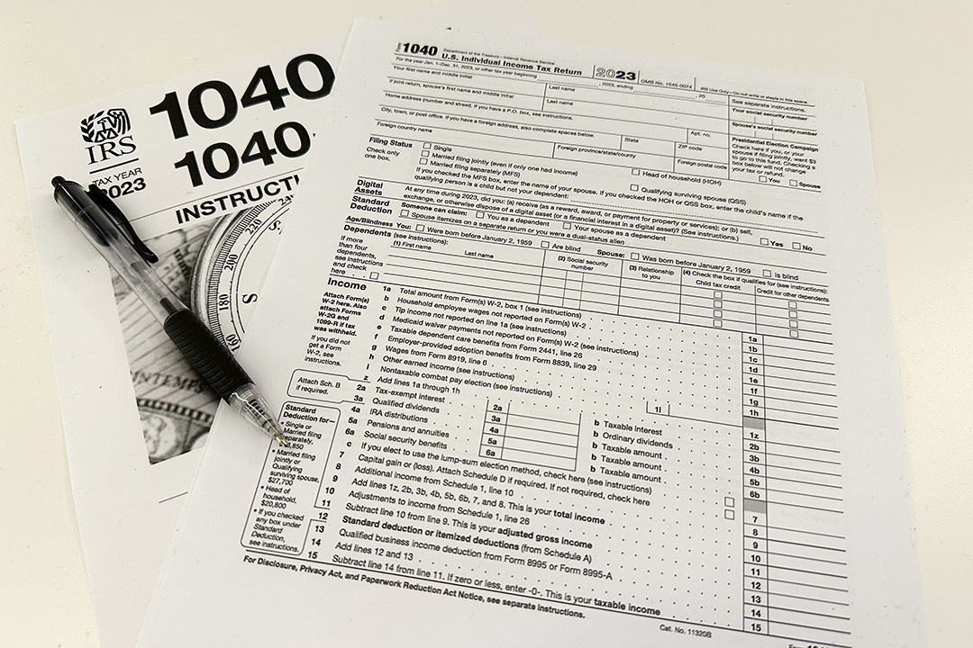 An Internal Revenue Service 2023 1040 tax form and instructions are shown on Friday, Jan. 26, 2024. For many people filing U.S. tax returns — especially those doing it for their first time — it can seem like a daunting task. (AP Photo/Peter Morgan)